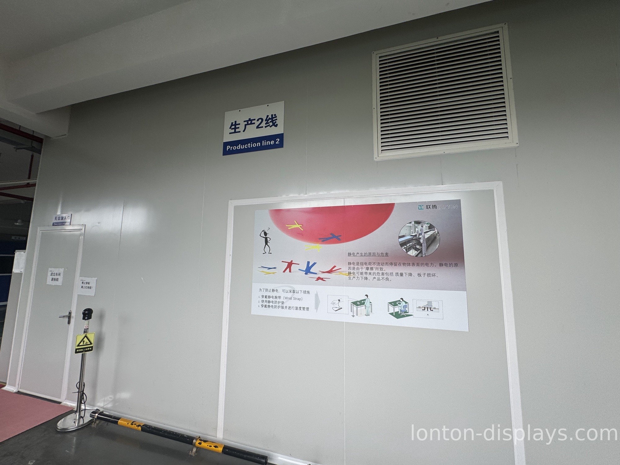 Technicians assembling interactive flat panels in a cleanroom